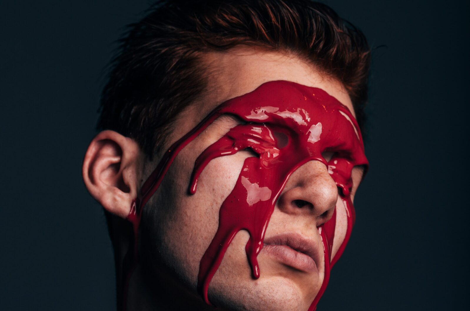 Man with red paint flowing from eyes