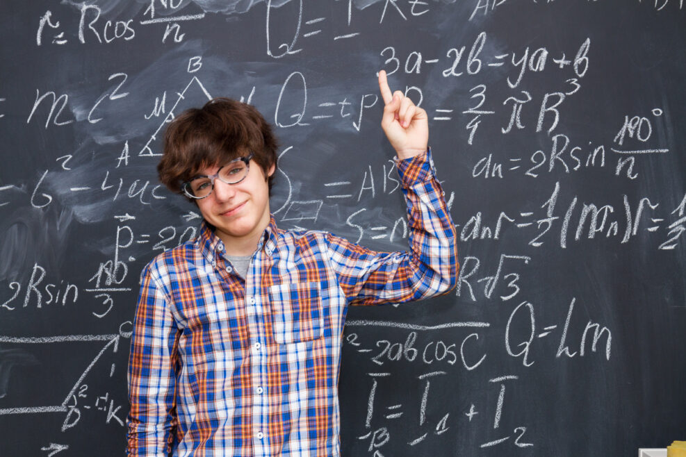 boy in glasses, blackboard filled with math formulas background