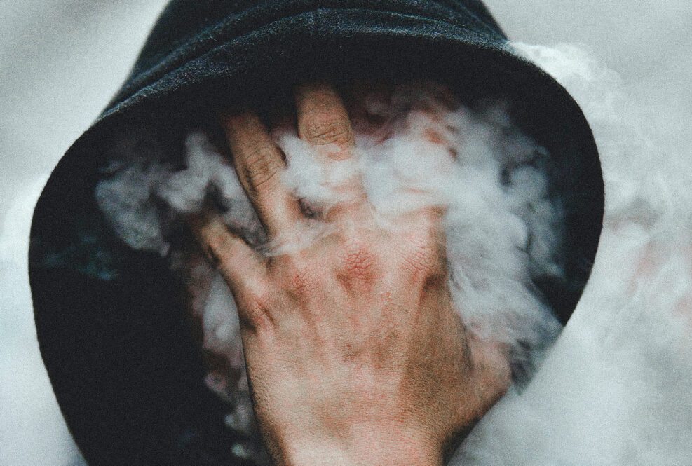 Hoodie with smoke in front of face