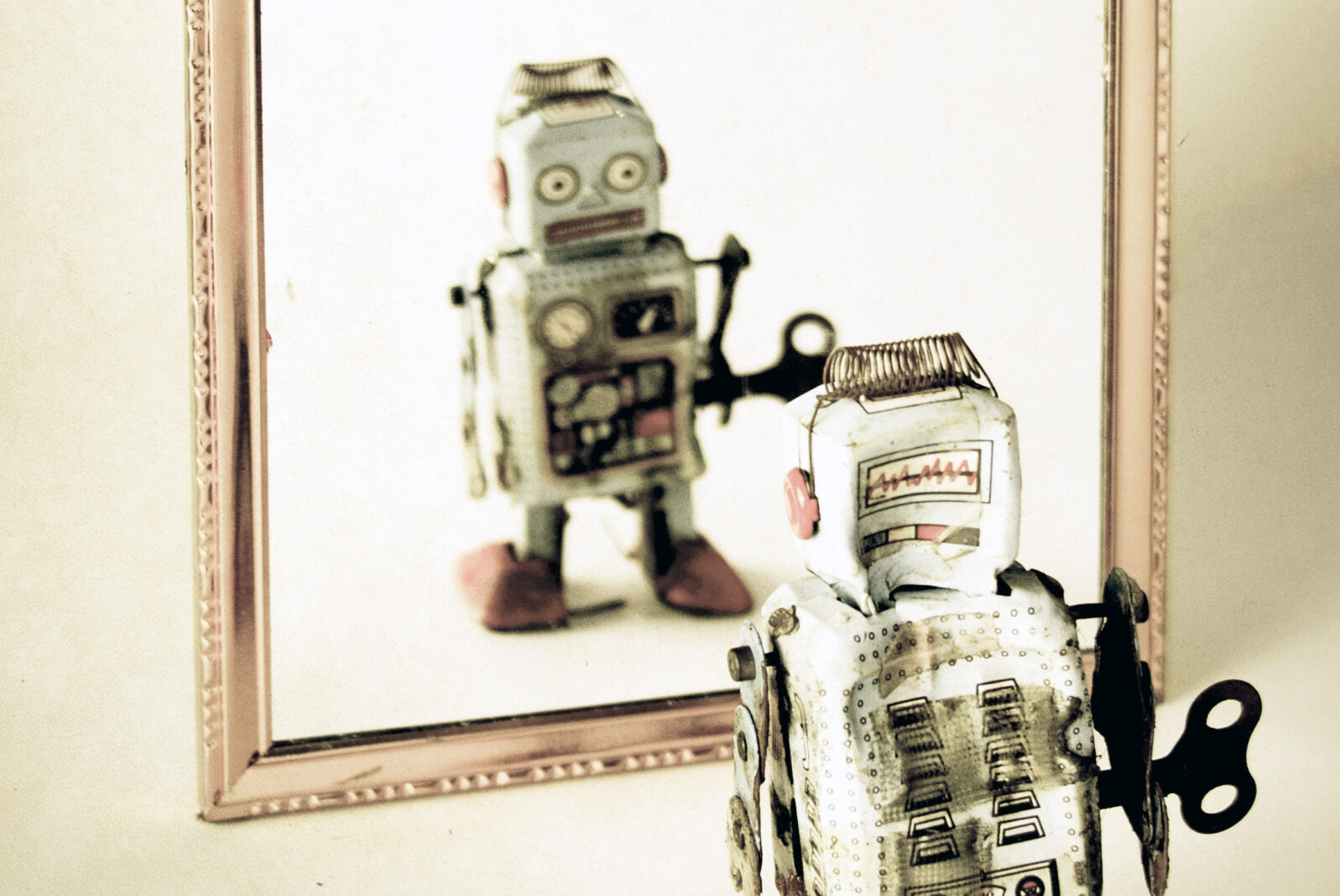 Toy Robot looking at itself in mirror