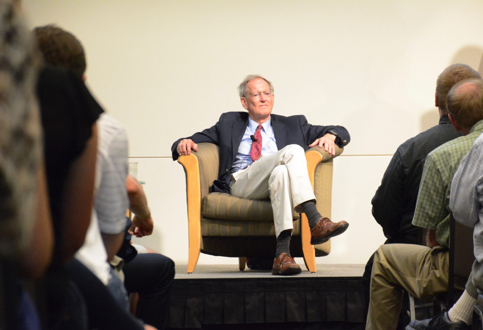 George Gilder seated before speech at book launch