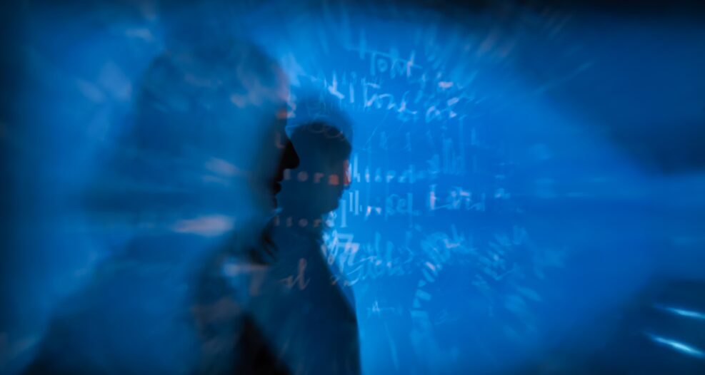 Silhouette of a person with words and numbers in the background
