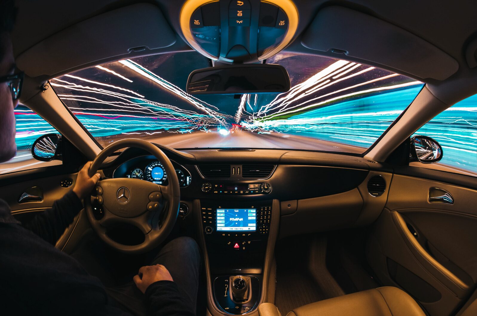 Photo from driver's seat with light trails ahead