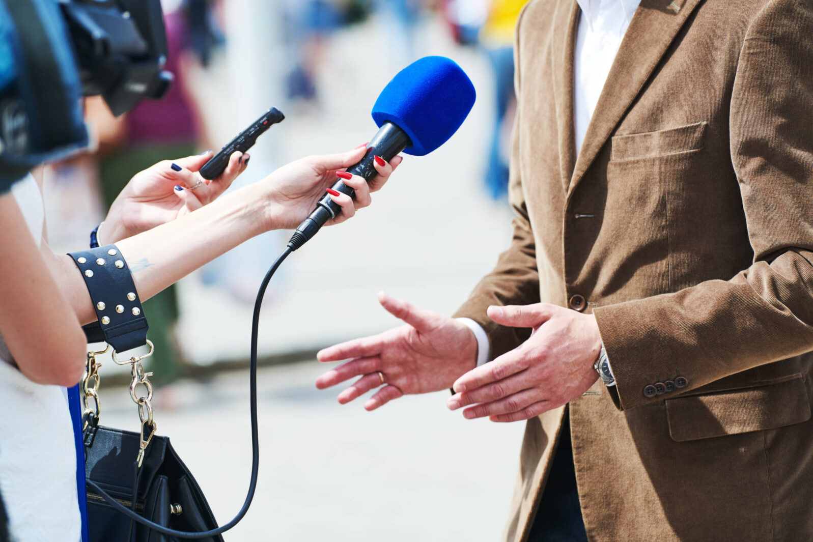 media reporter with microphone making journalist interview for news