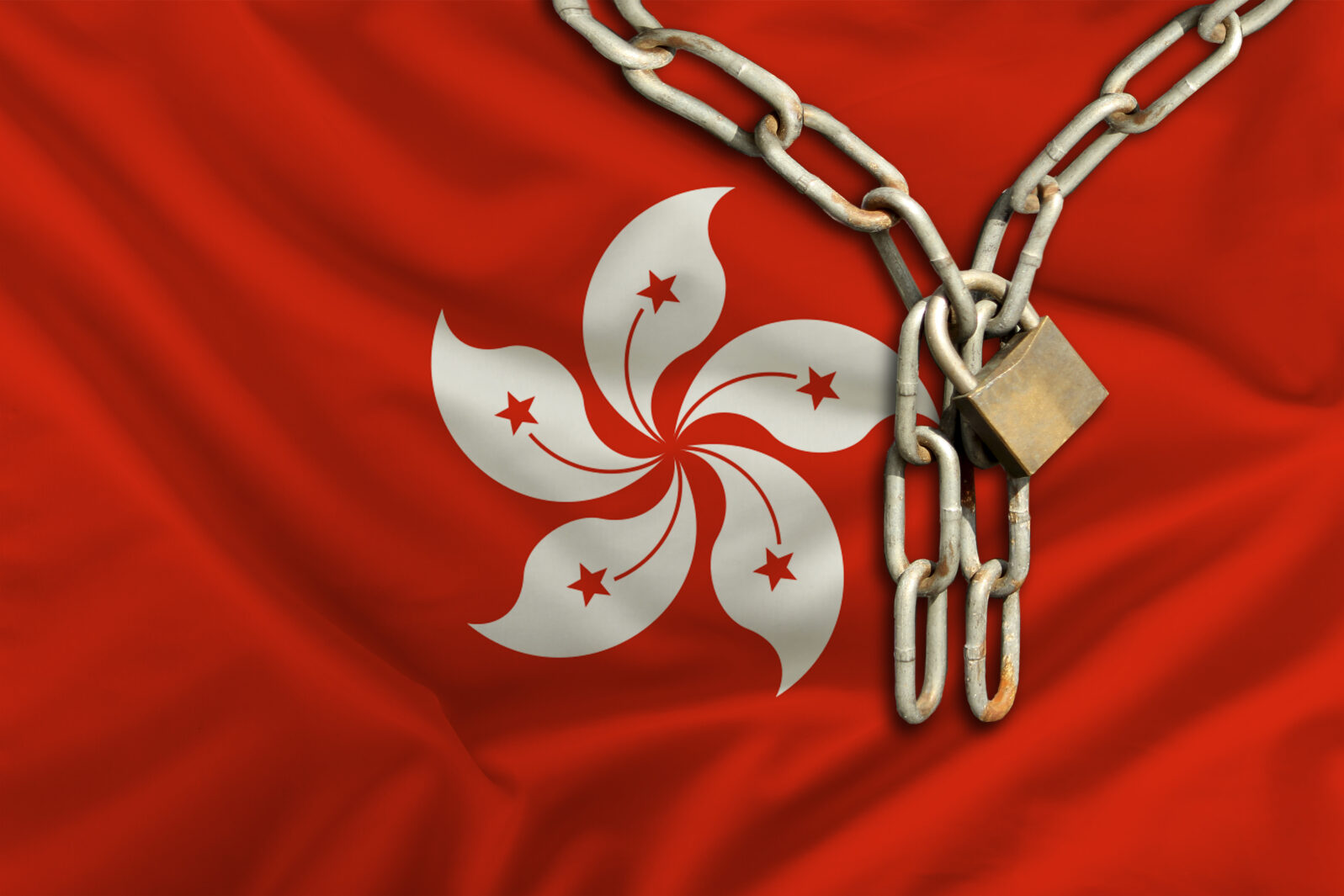 iron chain and castle on the silk national flag of Hong Kong with beautiful folds, the concept of a ban on tourism, political repression, crime, violation of the rights and freedoms of citizens