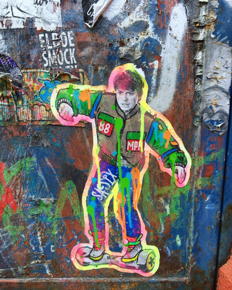 man riding on self balancing board graffiti