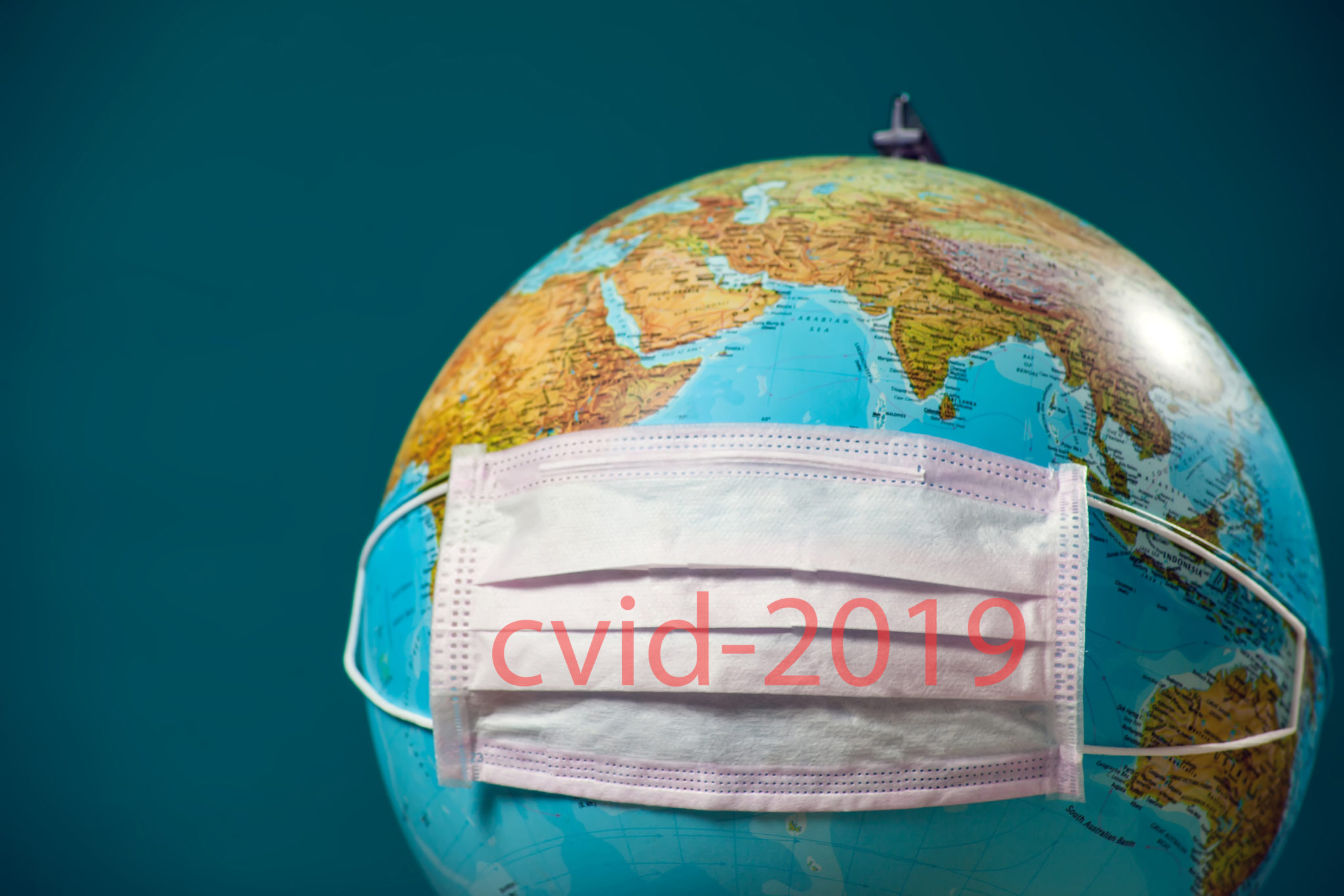 Medicine  face mask with name of coronavirus covid-2019 on the globus. World epidemic of coronavirus.