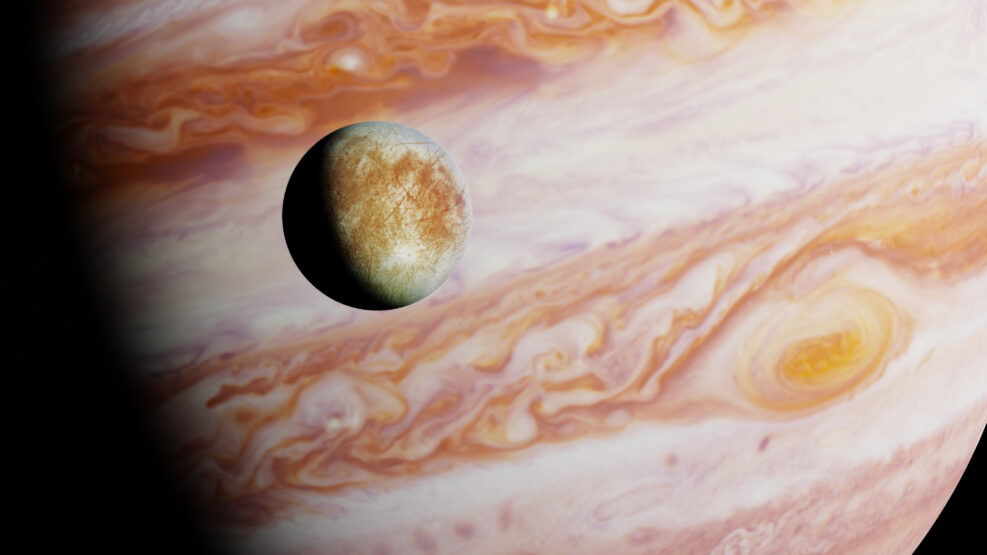 Jupiter's moon Europa in front of the planet Jupiter