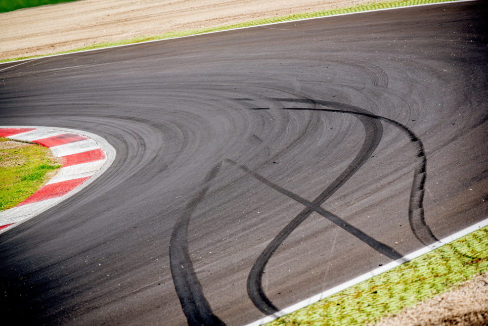 Motorsport racing track and car slammed brakes sign