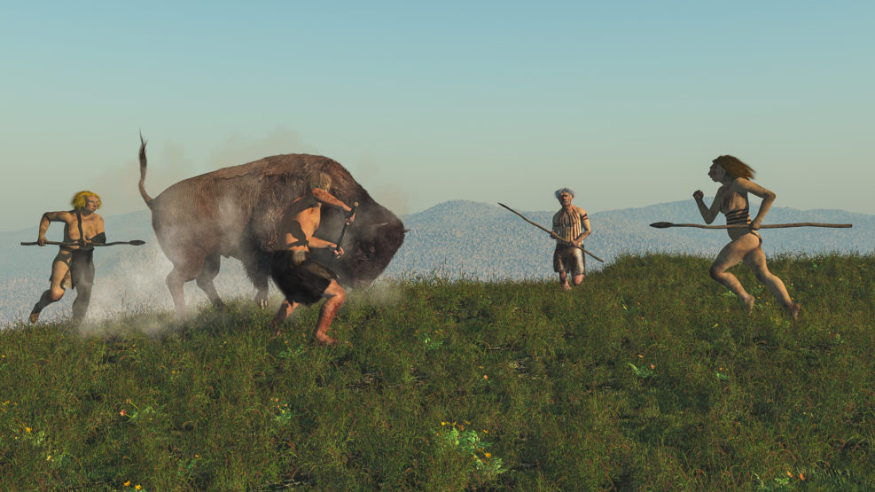 Group of neanderthal hunting a bison