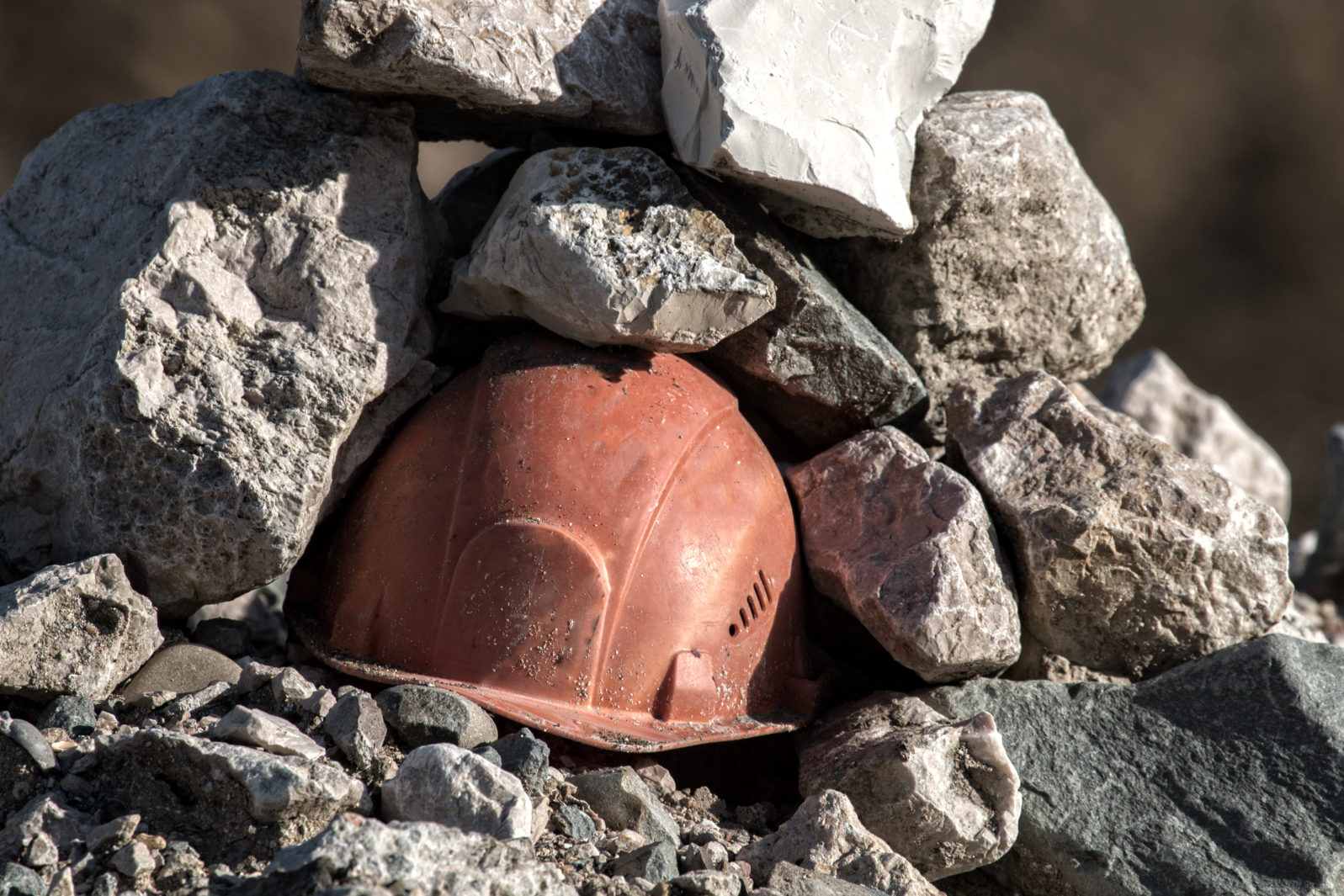 Working helmet on a pile of stones