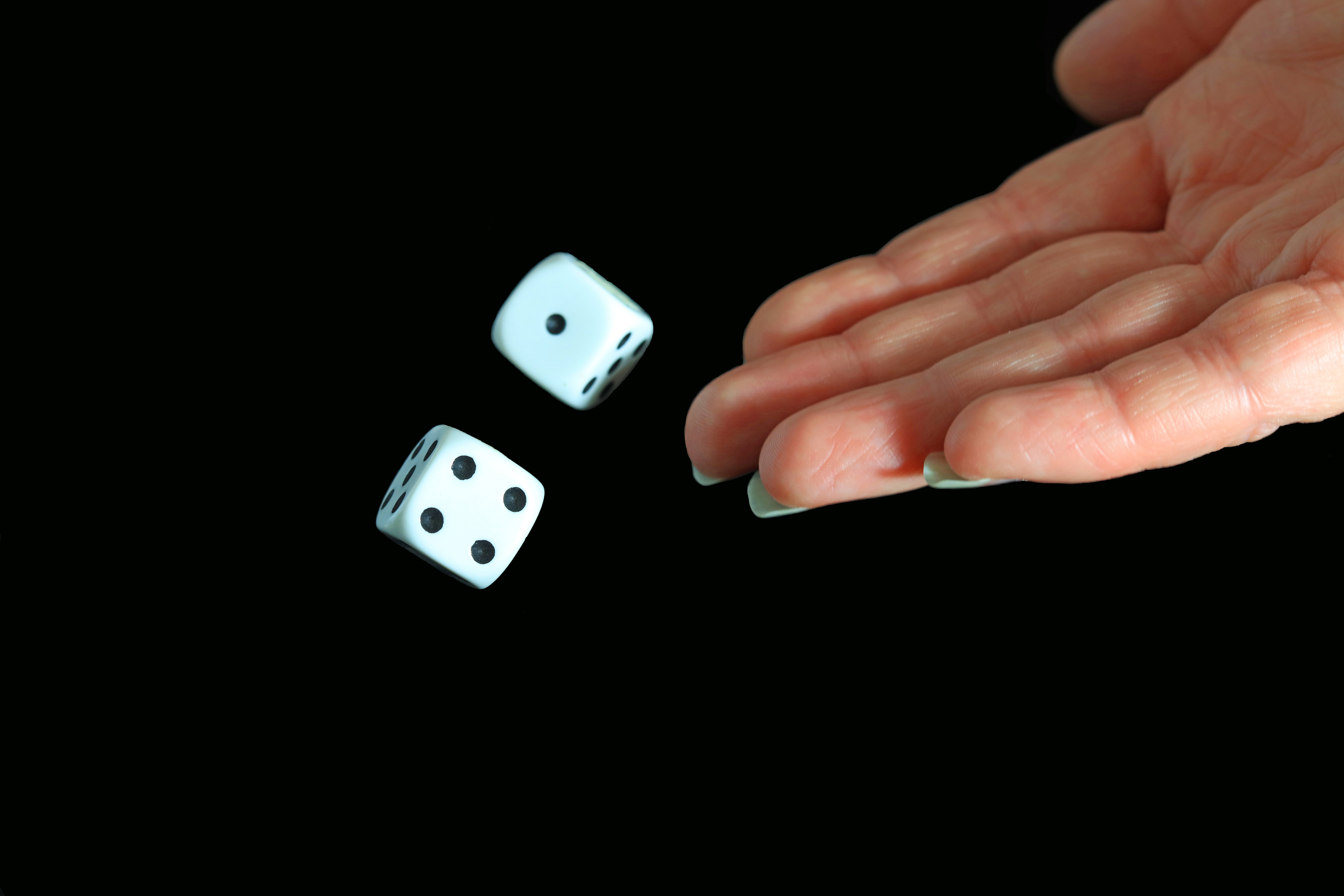 a hand rolling dice