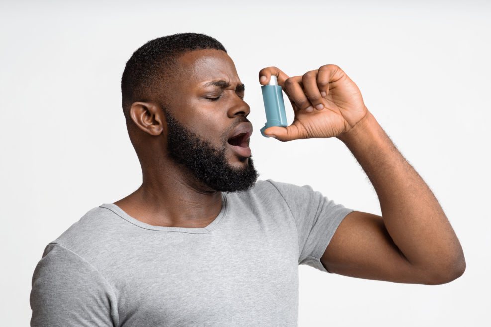 Picture of a young man having an asthma attack