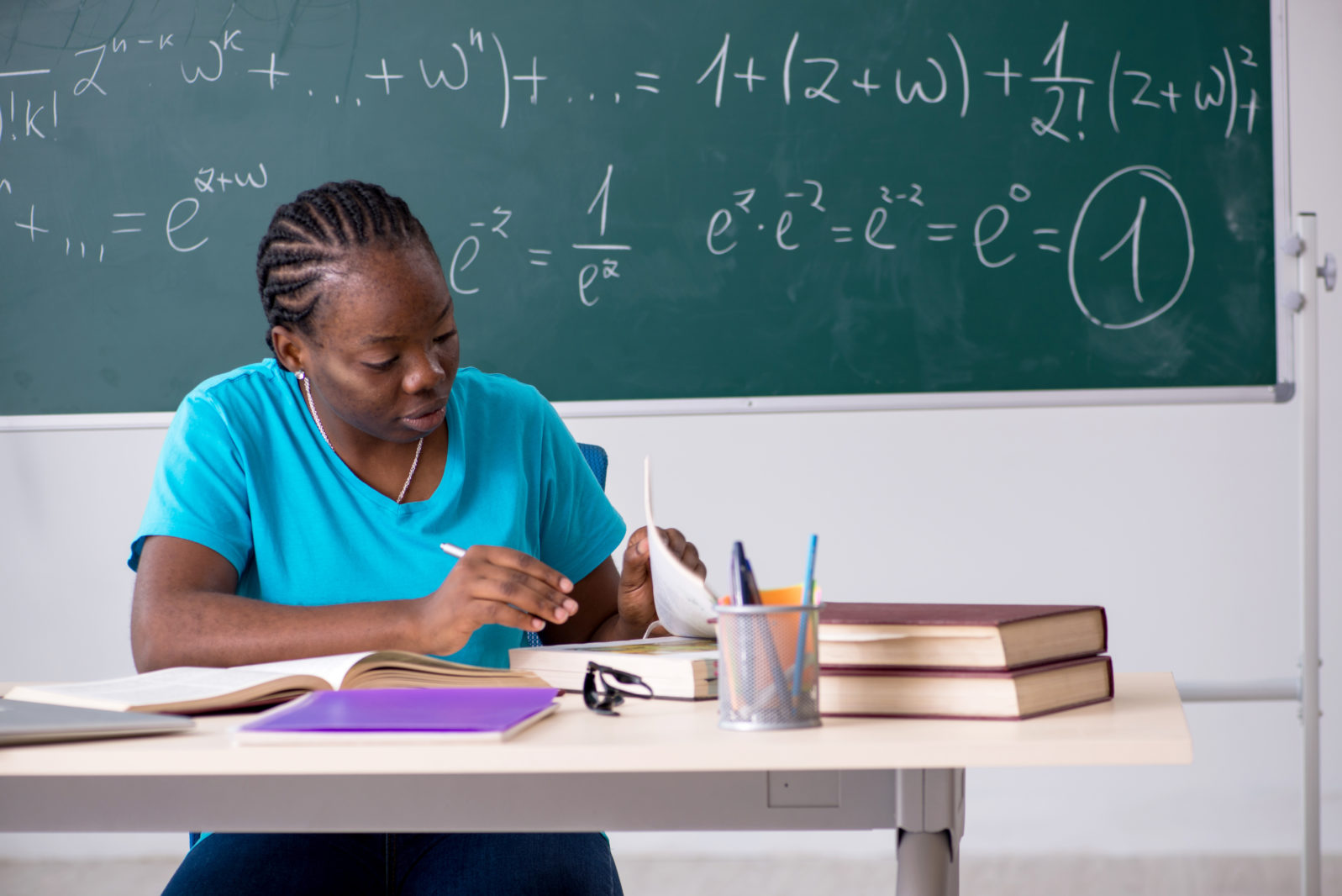 Black female student in front of chalkboard