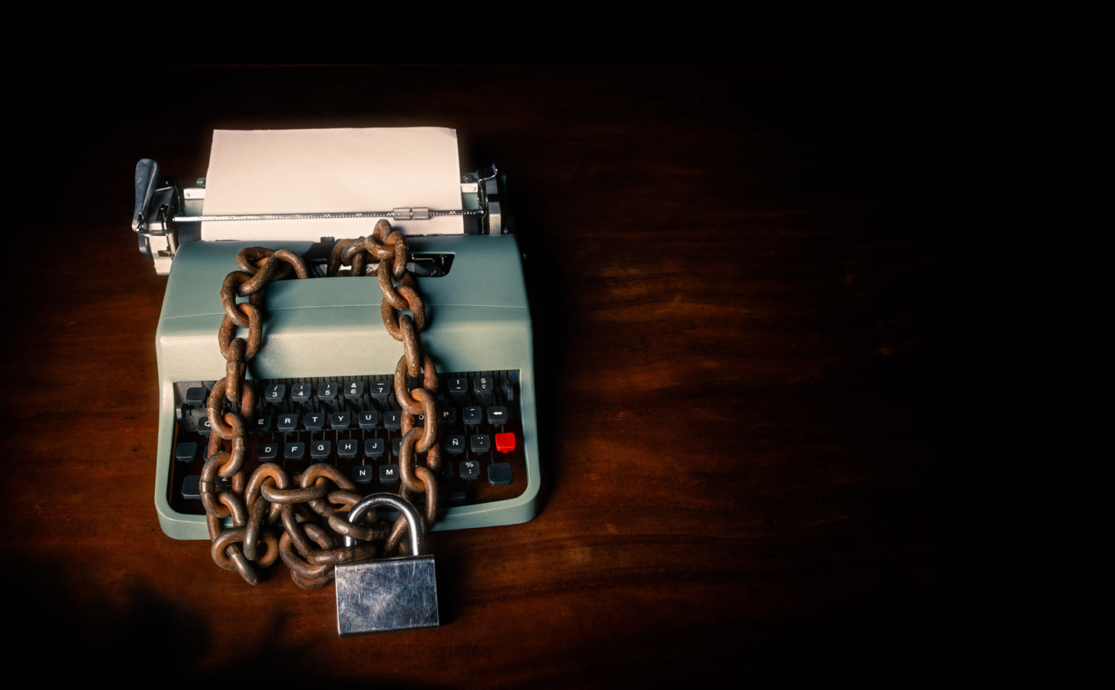 Information censorship - Typewriter locked with a chain