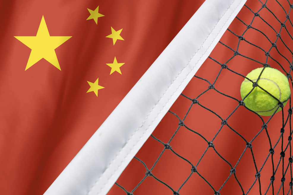 Tennis ball in net on flag China background.