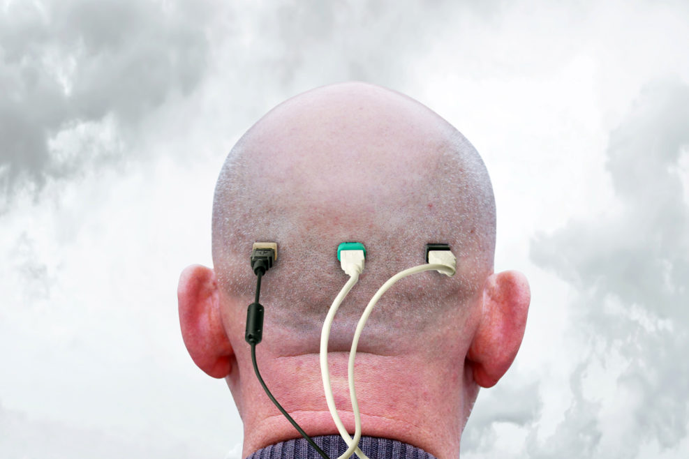 Shaved male nape and a lot of usb cables connected to it. Concept of dependence in thinking and information