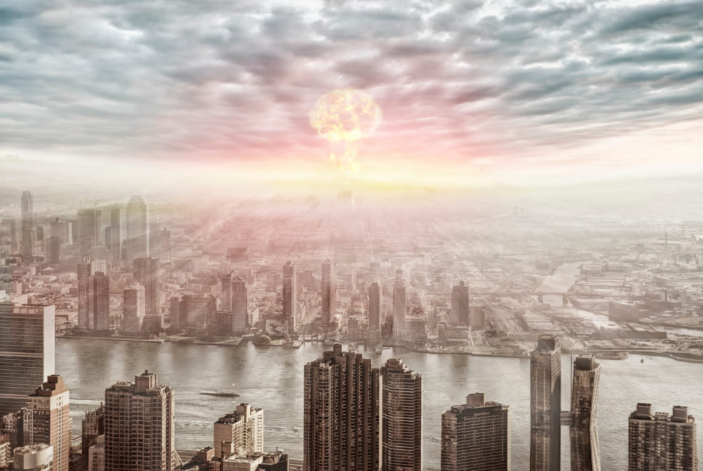 Aerial view of nuclear explosion over a city.