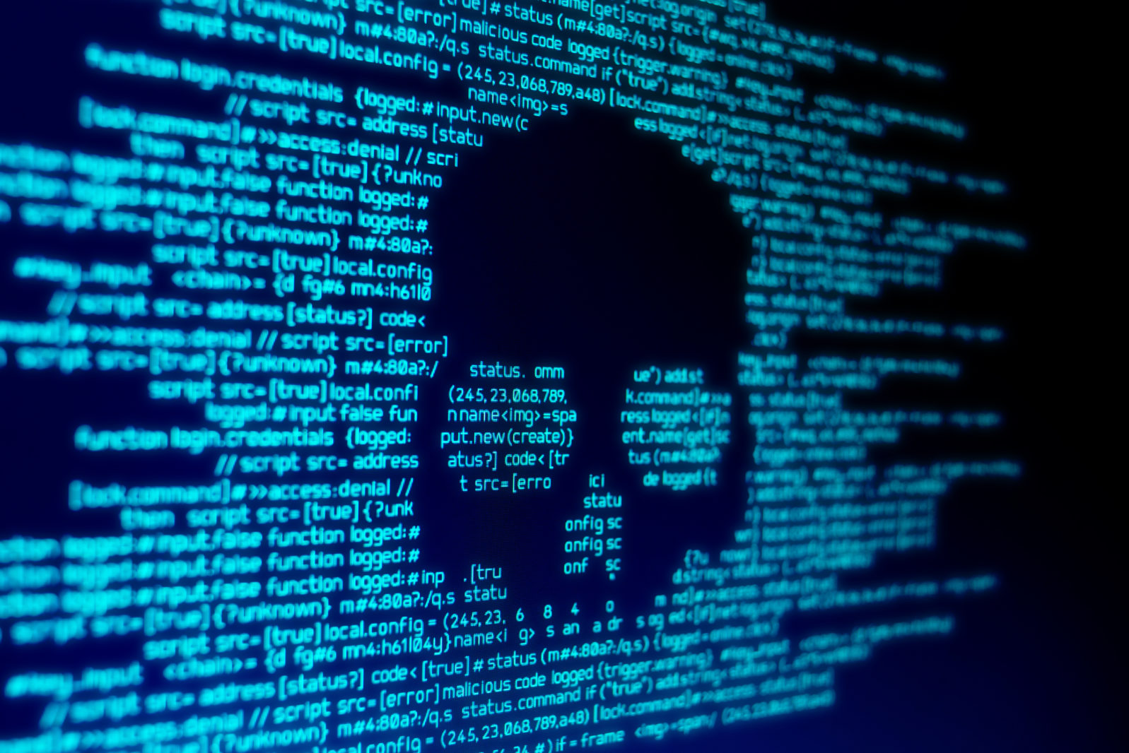 Computer code on a screen with a skull representing a computer virus / malware attack.