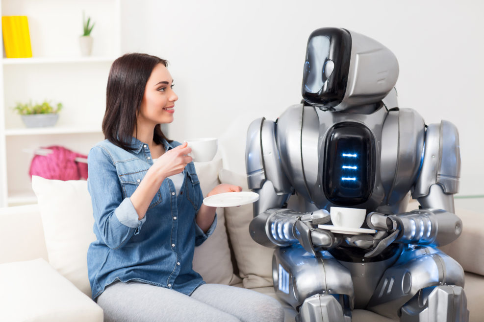 Positive girl resting on the couch with robot