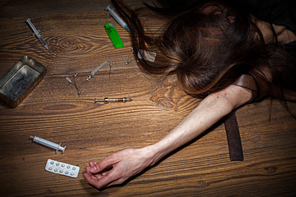 Young woman poses as drug addict.