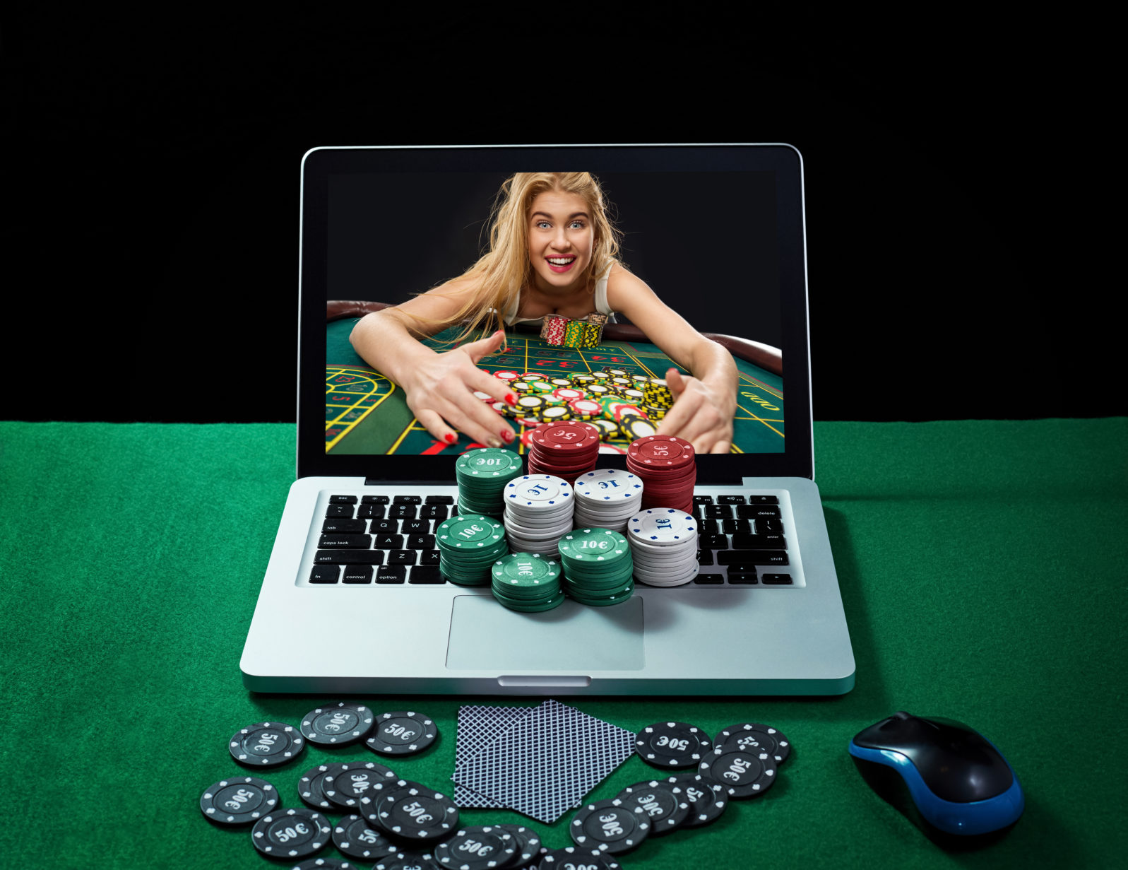 Green table with casino chips and cards on notebook
