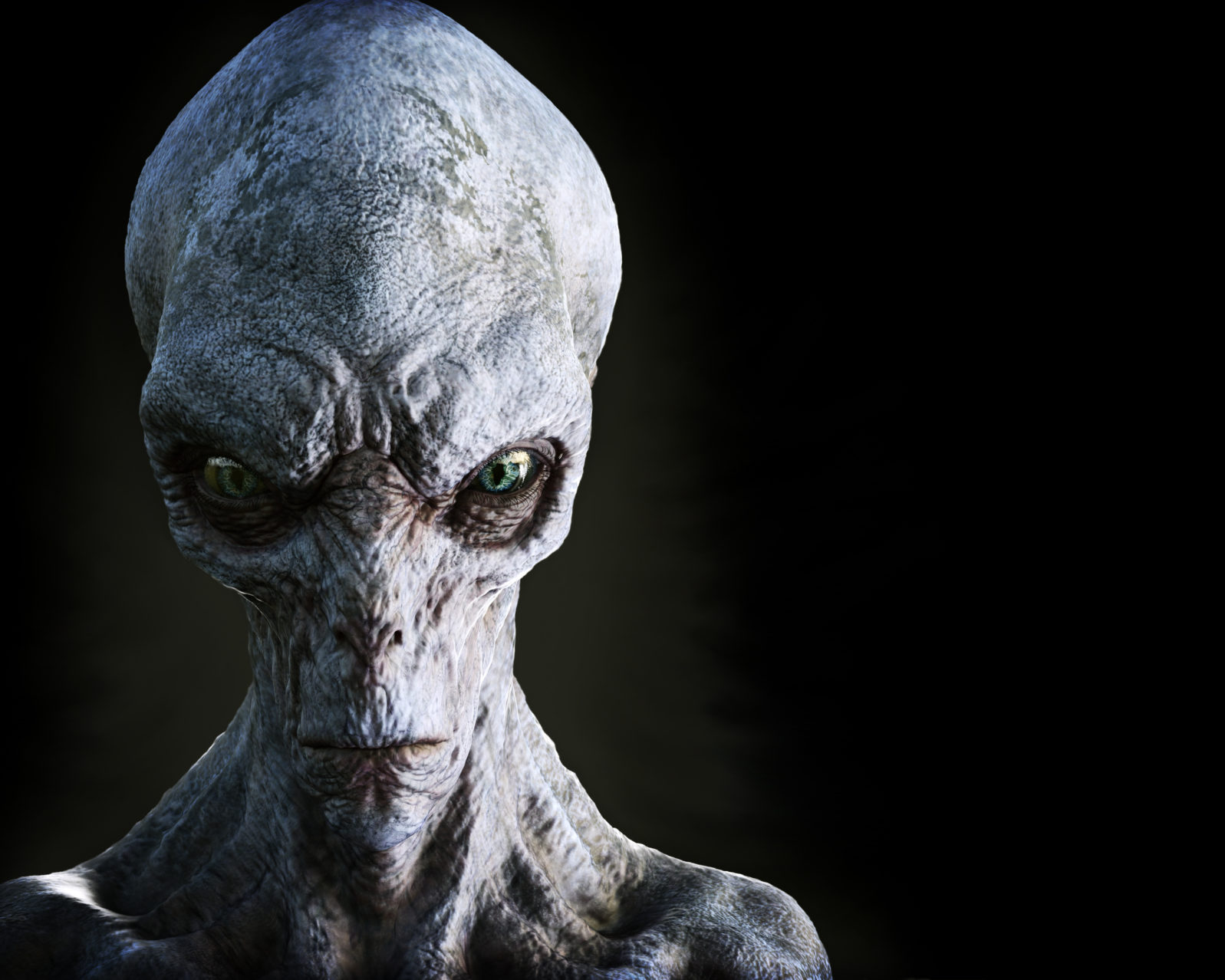 Portrait of an alien male extraterrestrial on a dark background with room for text or copy space. 3d rendering