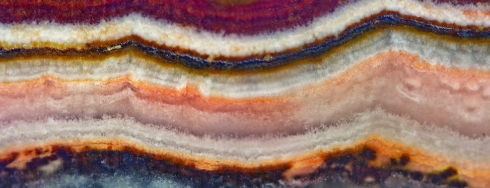 Agate surface background. Multicolor transparent crystal background. Macro