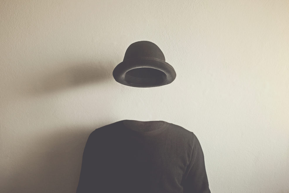 invisible man wearing black bowler, surreal concept of absence of identity