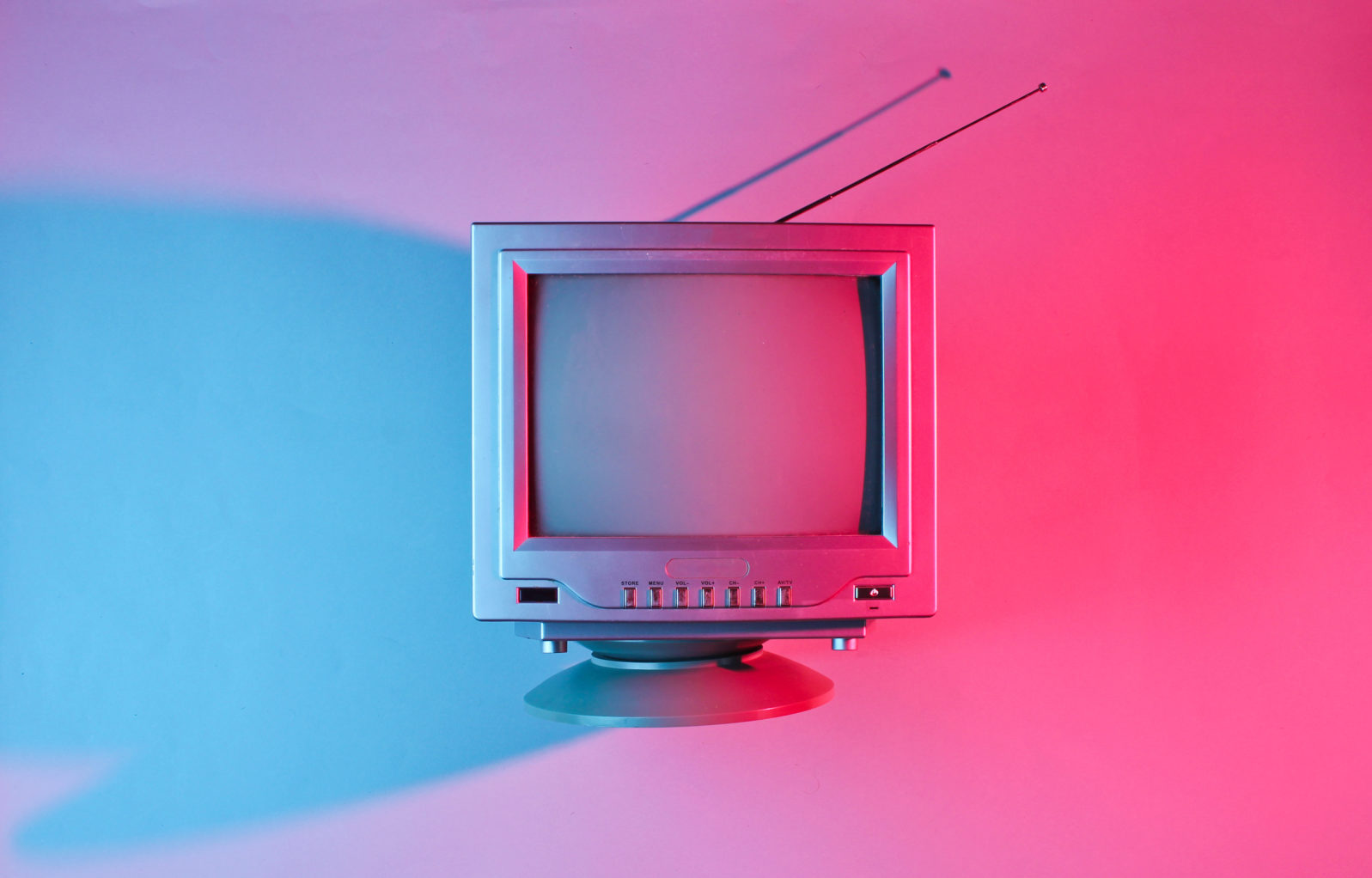 Retro wave, 80s. Old tv with antenna with neon light. Top view, minimalism