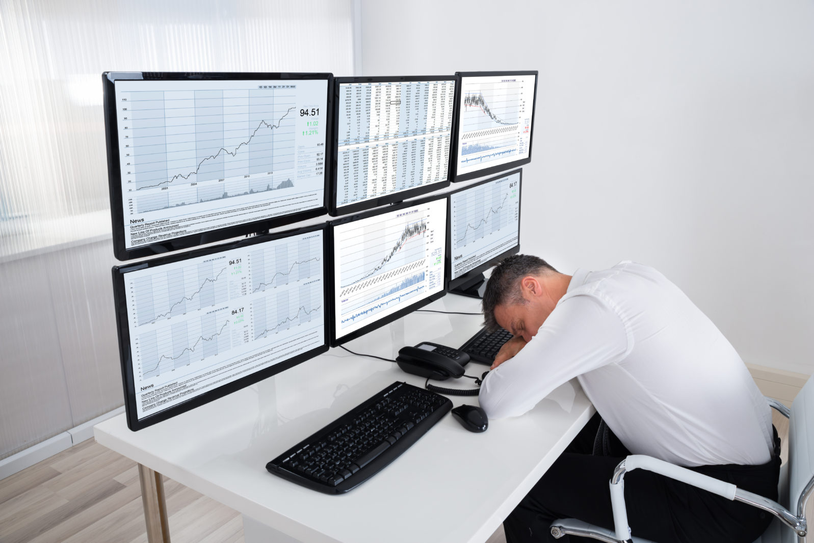 Stock Trader Sleeping At Multiple Computer's Desk