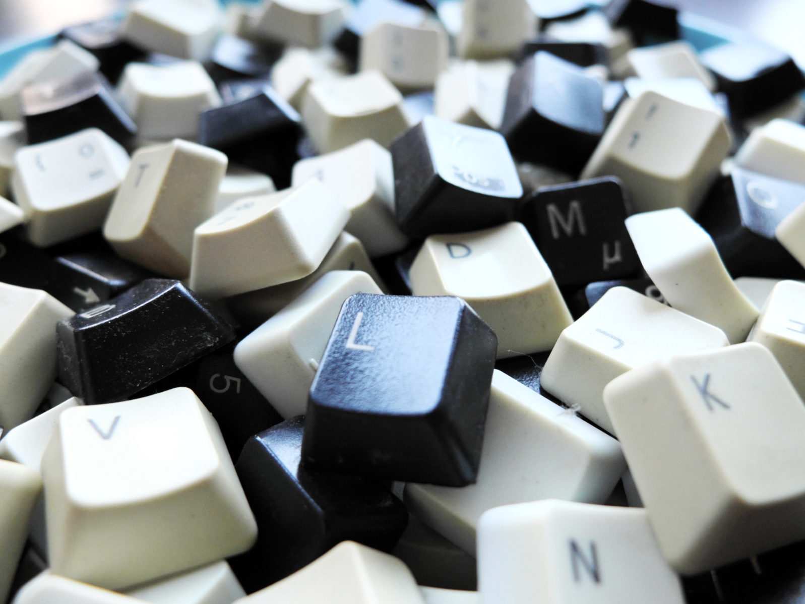 Black and white computer keyboard keys close-up. Concept of unstructured big data that need to be sorted ready to be consumed by machine learning model for deep learning.