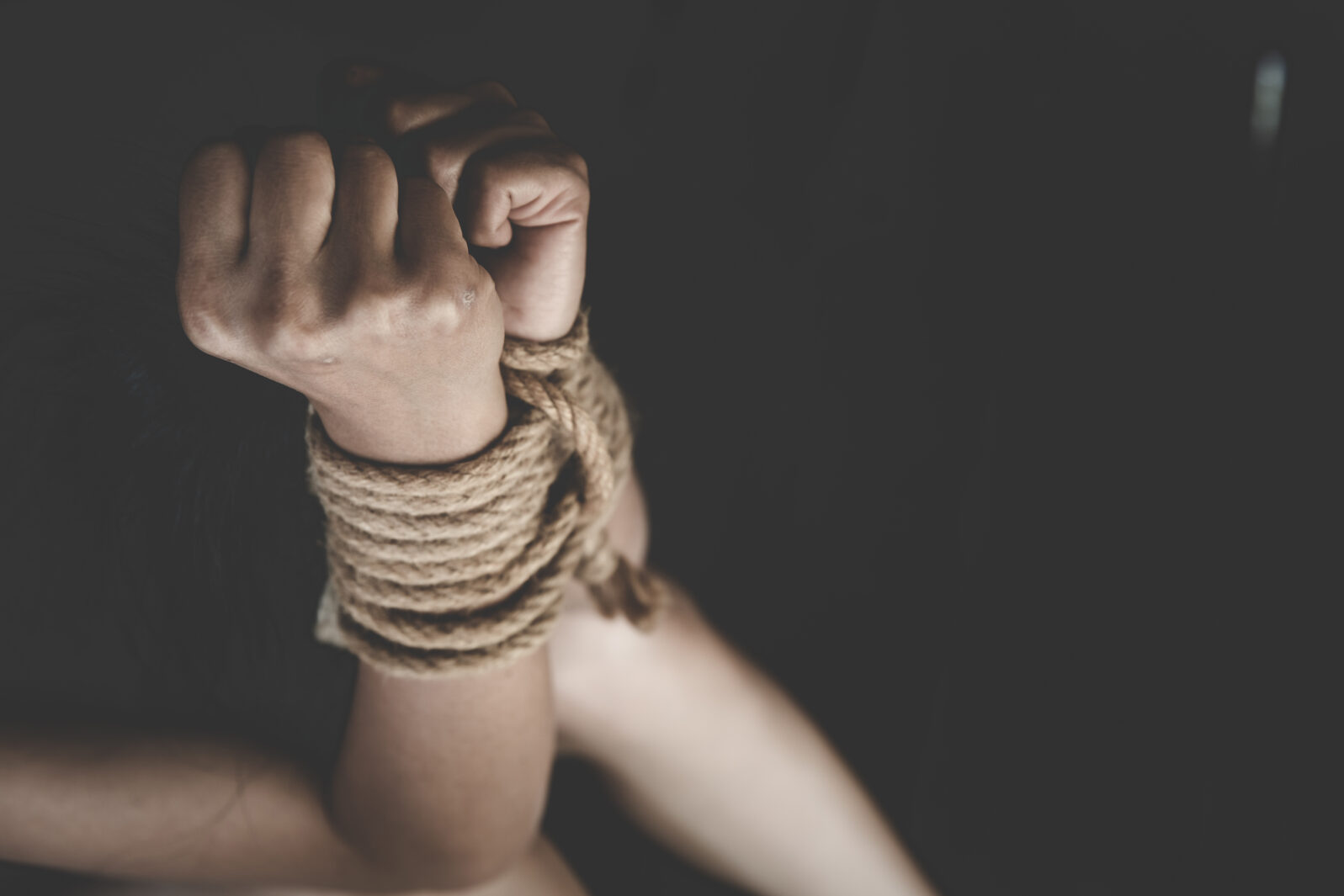 Victim boy with hands tied up with rope in emotional stress and pain,  kidnapped, abused, hostage,  Stop violence against children and trafficking Concept.