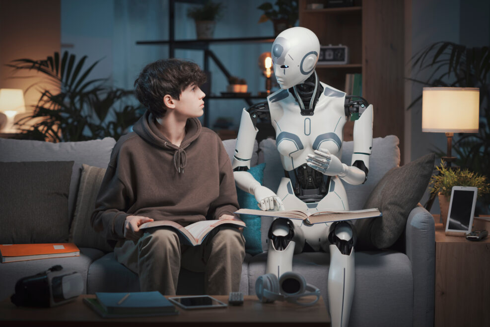 AI robot tutor reading with a teenage boy
