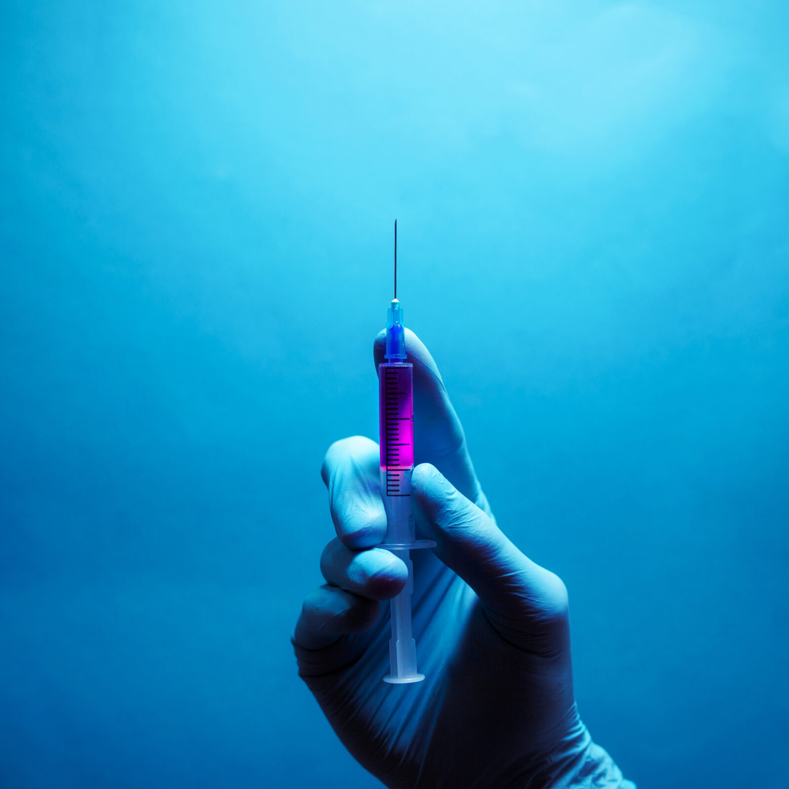 Beauty injection concept. Syringe with violet liquid for hypodermic injection.