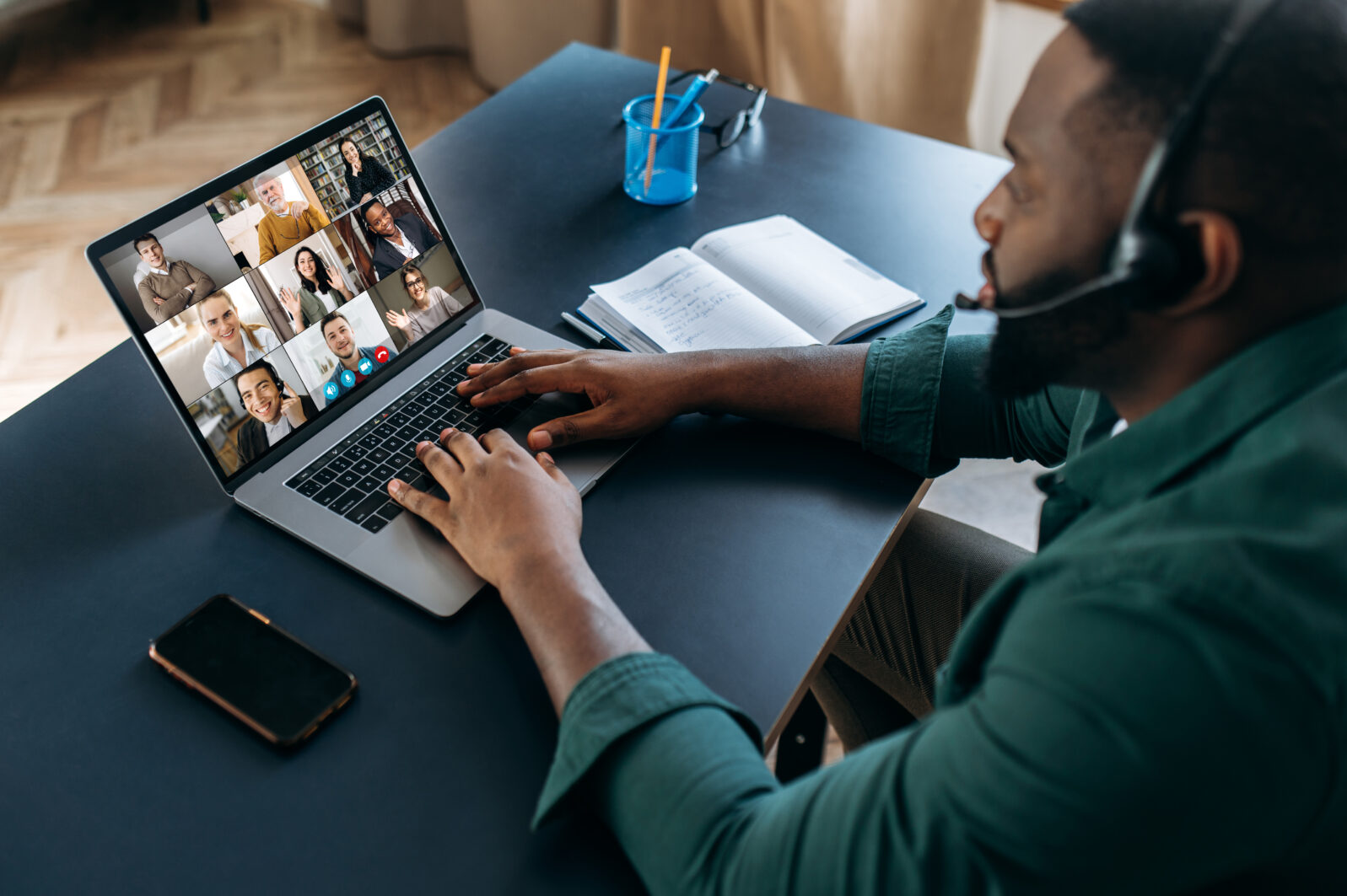 Business brainstorm, online video meeting, virtual conference with multiracial colleagues. African American man communicate with business partners by video call uses laptop and app, work from home