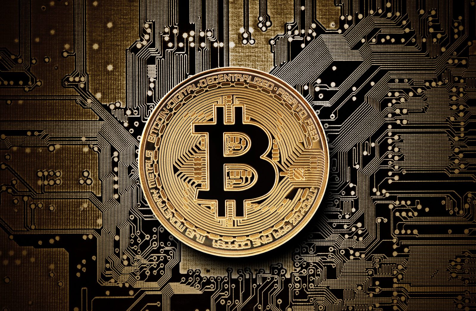 Bitcoin golden coin on computer circuit board