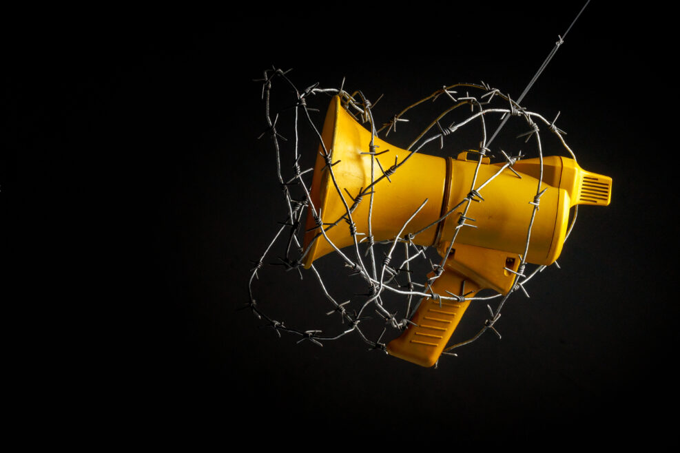 megaphone wrapped in barbed wire. the concept of banning freedom of speech. censorship barbed wire megaphone