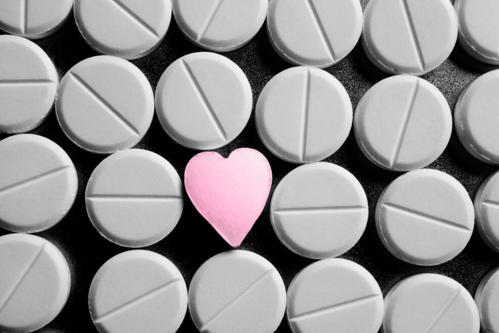 Heart shaped pill between rows of standard pills
