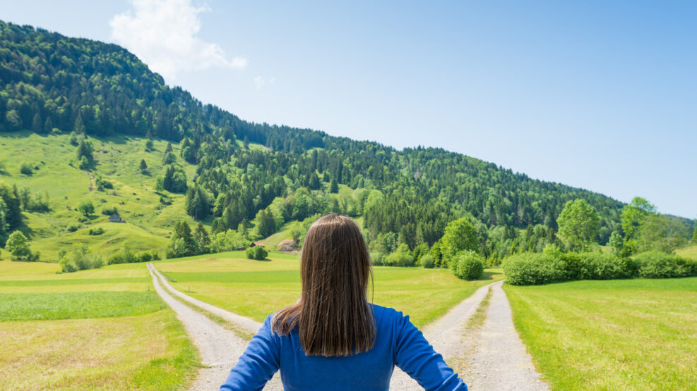 A choice of two ways. Woman at a crossroads.