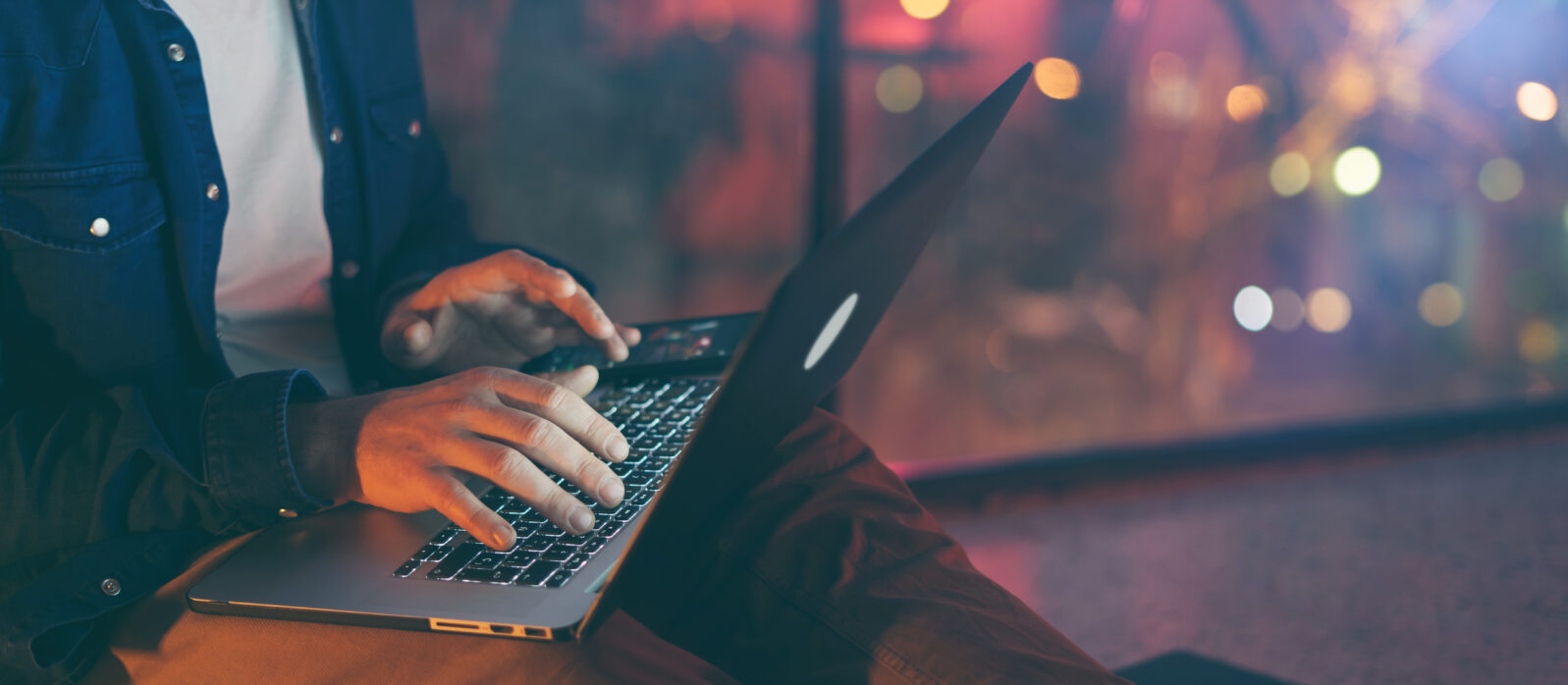Man working on laptop at night