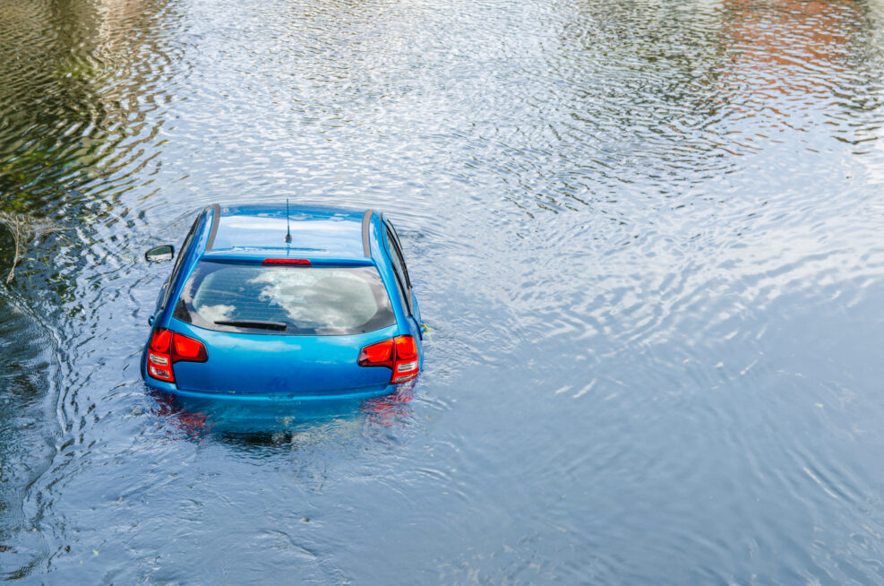 Blue car drown in water canal. Extreme accident vehicle sink in river pound lake, traffic incident