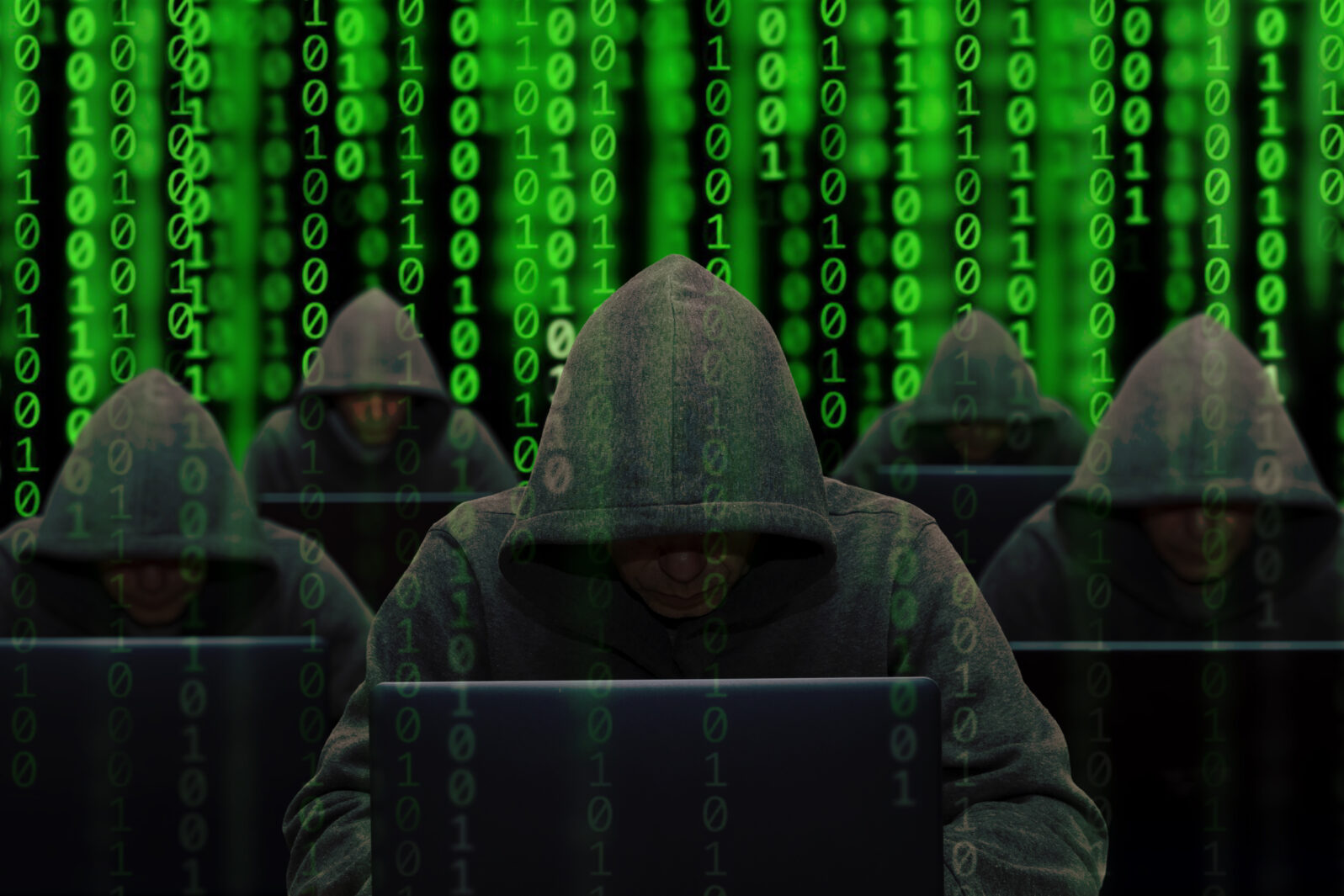 Hackers are sitting at laptops and computers on an abstract background, attacking and hacking servers with a virus. Creation and dissemination of disinformation, DDOS attack.