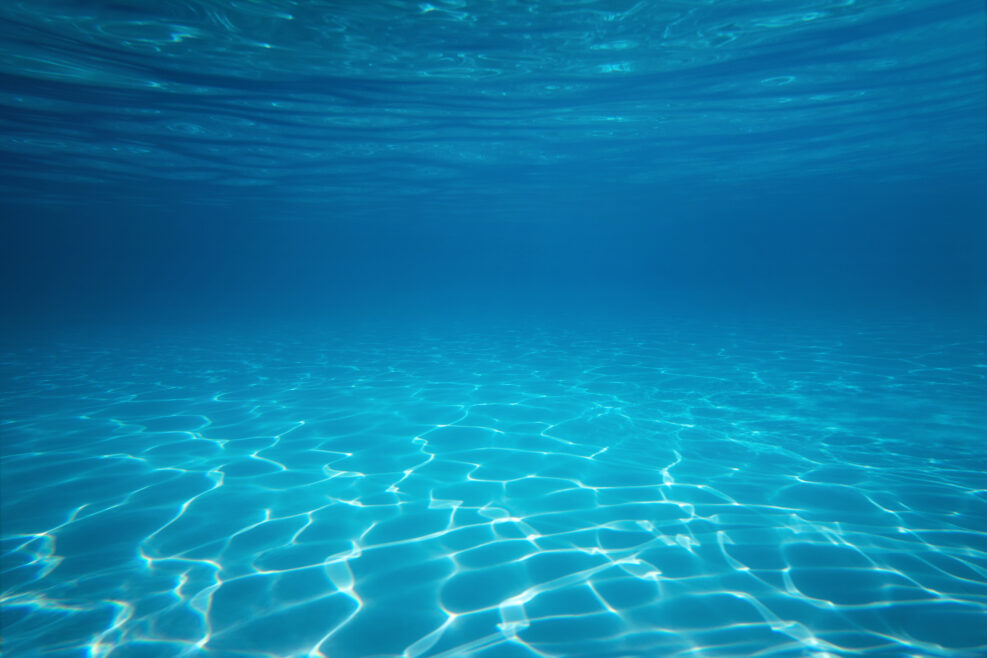 Underwater empty swimming pool background with copy space