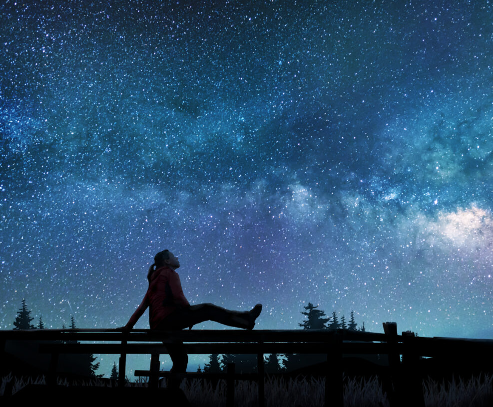 Girl watching the stars in night sky