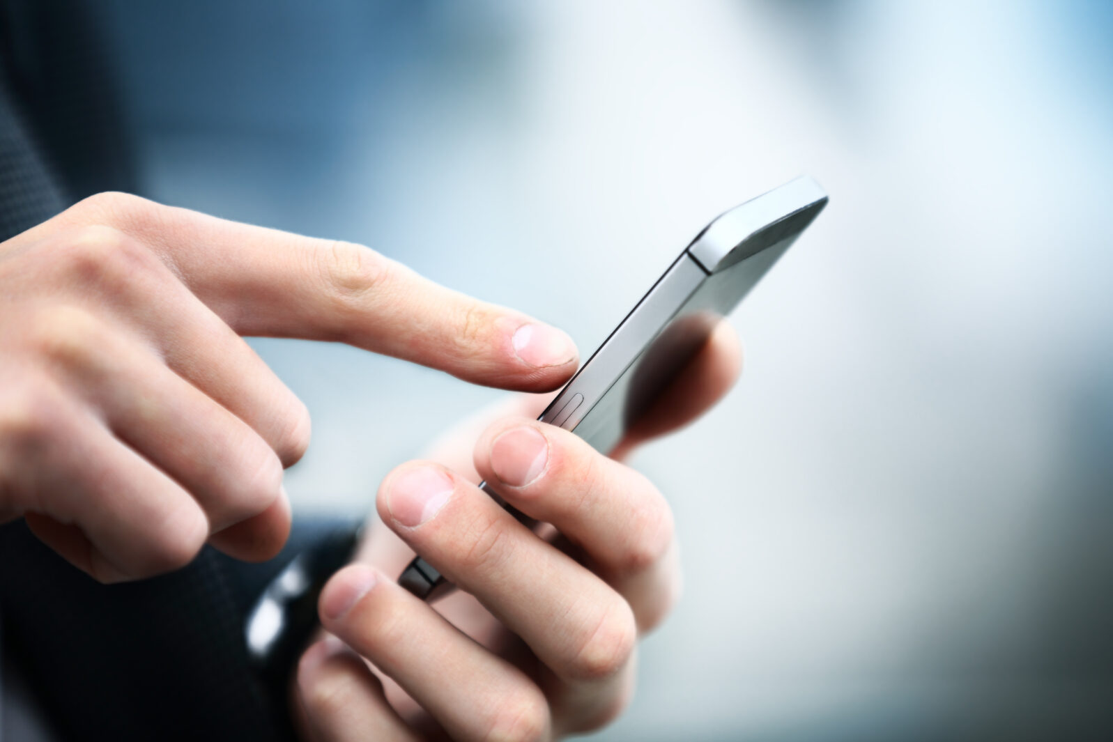 Close up of a man using mobile smart phone