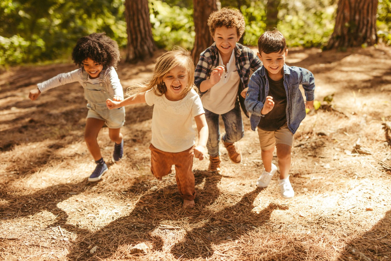 Kids running up in the forest