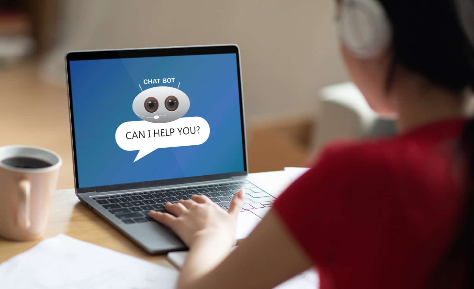 Unrecognizable woman student using chat bot on laptop