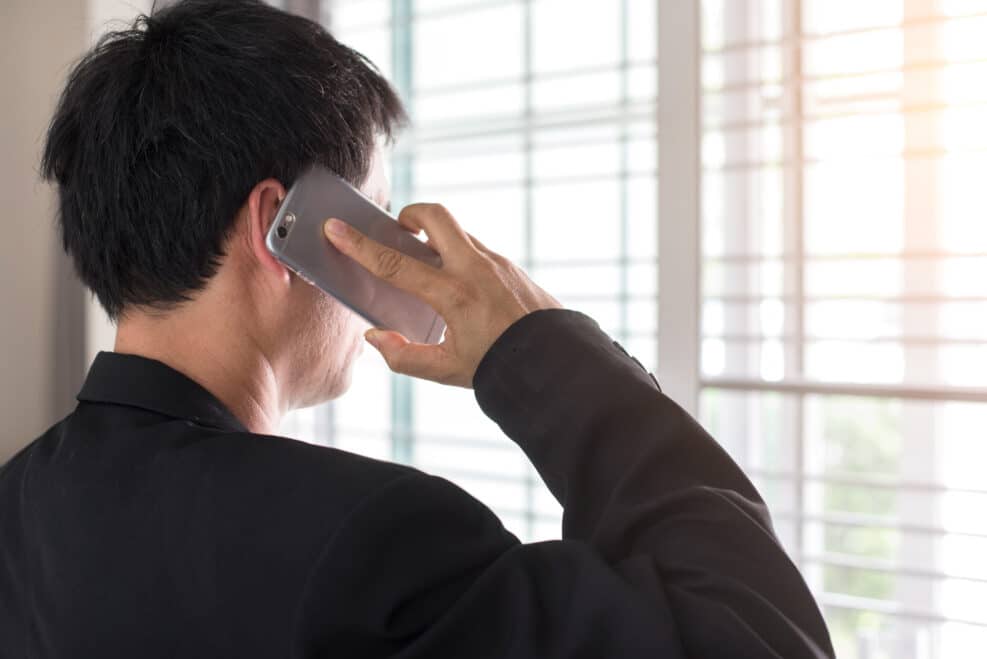 Business man making a phone call with smartphone.