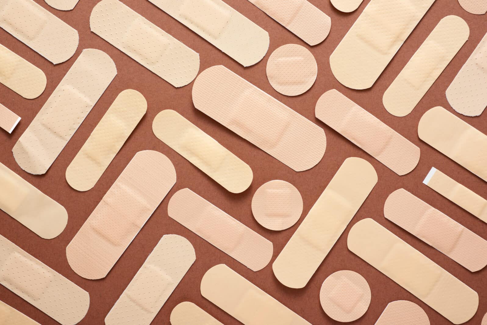 Some band-aids on a brown table